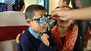 Boy being tested for myopia in India